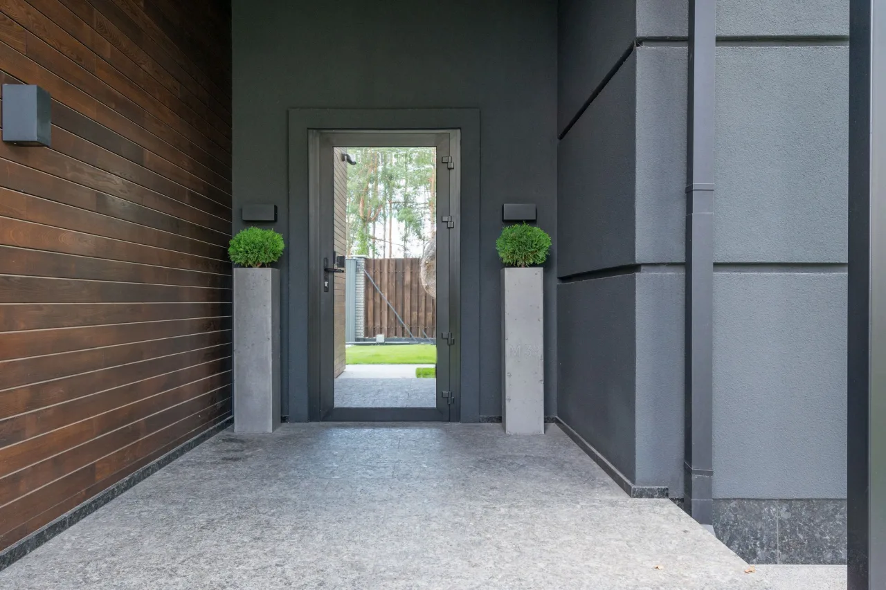 Contemporary residential entrance with a full-height glass door